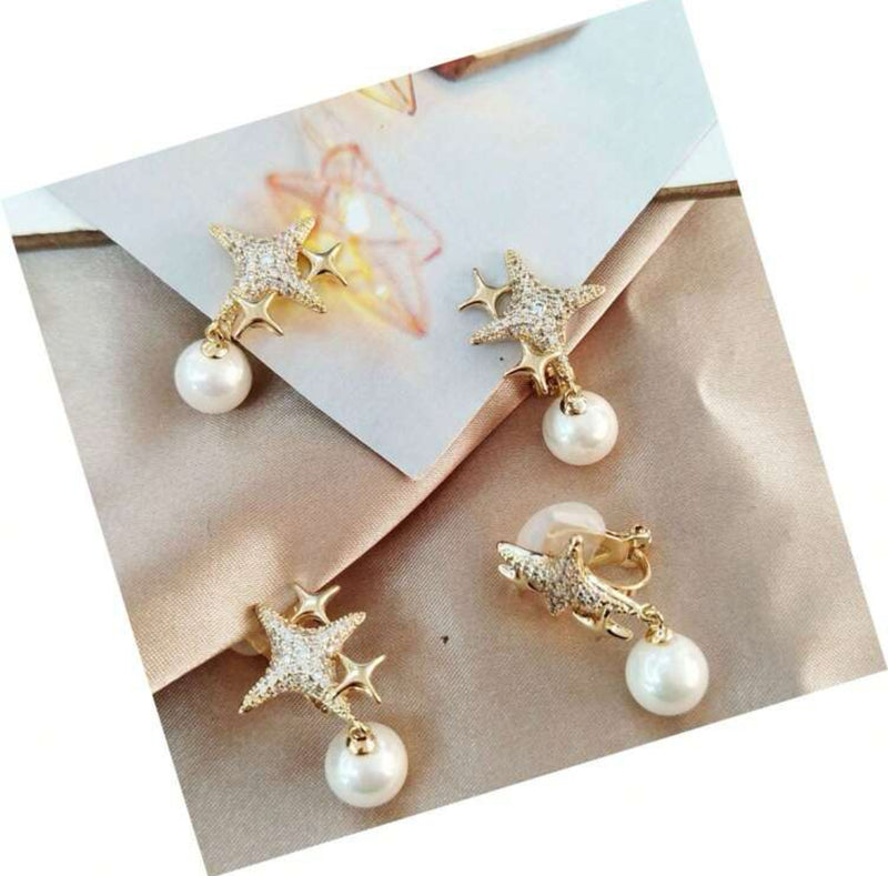 Clip on 1 1/4" gold and clear stone stars and white dangle pearl earrings