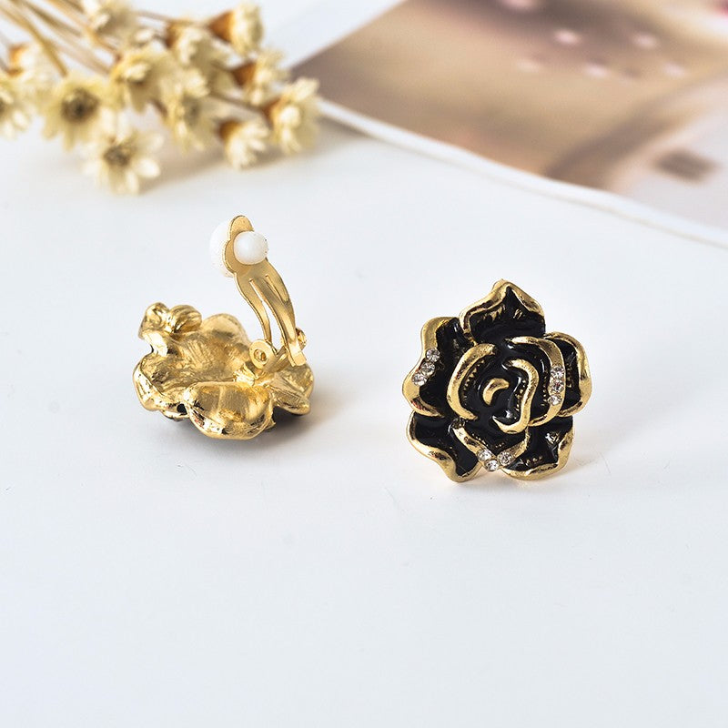 Clip on 1" gold and black flower button style earrings with clear stones