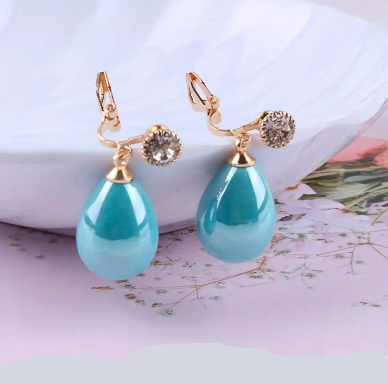 Clip on 1 1/4" gold and shiny blue dangle teardrop bead earrings