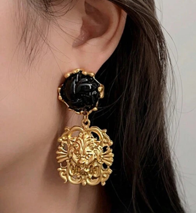 Clip on 2 1/2" matte gold and black woven stone earrings with dangle lion