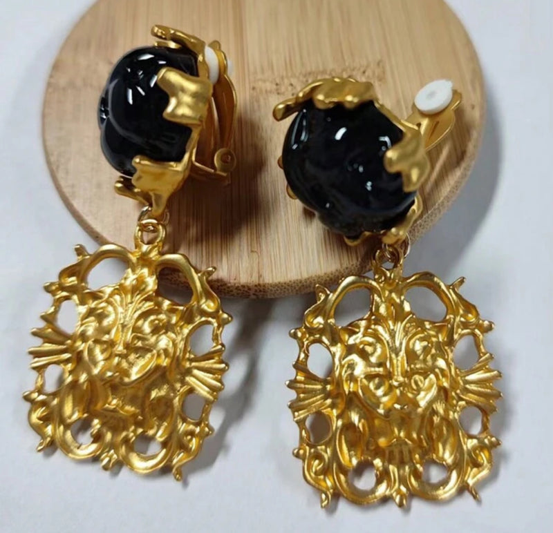 Clip on 2 1/2" matte gold and black woven stone earrings with dangle lion