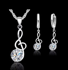 Sterling silver pierced hoop necklace set with music note and clear stone