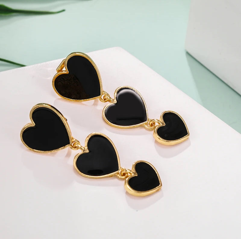 Trendy 2" clip on gold and black dangle three heart earrings