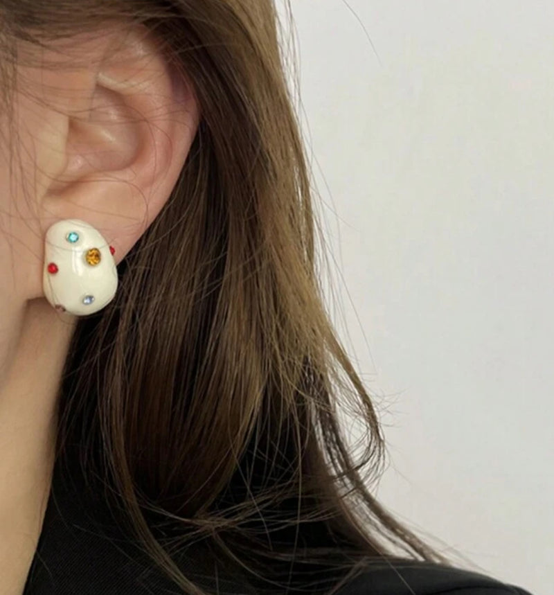 Clip on 3/4" gold and white earrings with multi colored stones