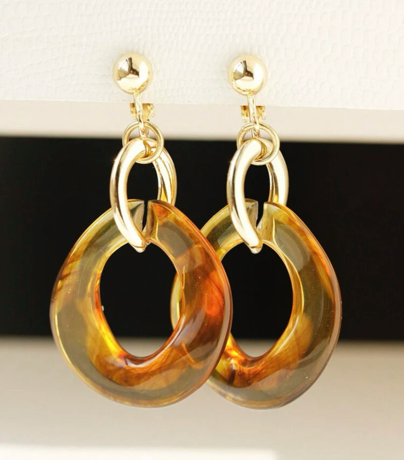 Clip on 2 1/2" gold odd shaped hoop earrings with orange shell circles
