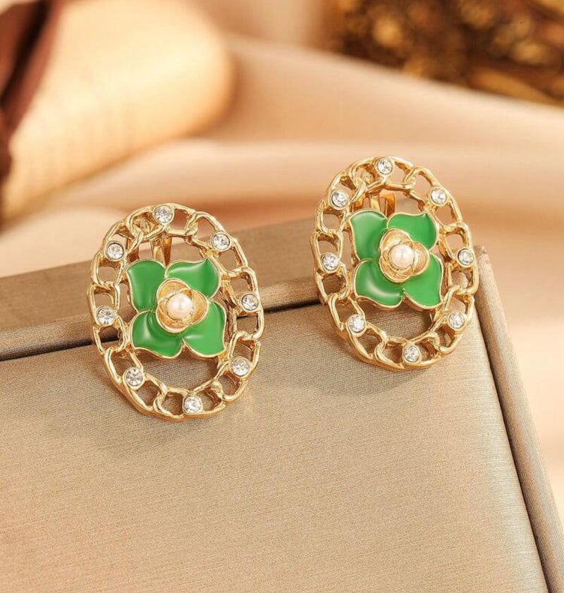 Clip on 1 3/4" gold cutout green flower earrings w/center pearl and clear stones