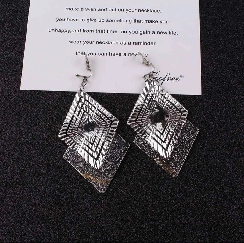 Clip on 3 3/4" long silver textured and indented square dangle earrings