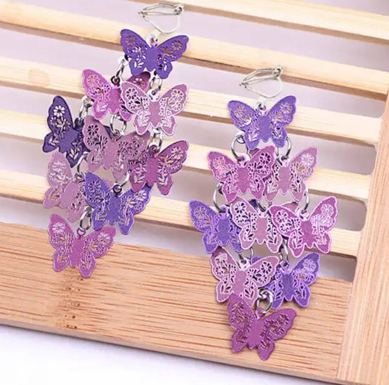 Clip on 2 1/4" silver and purple textured butterfly cluster earrings