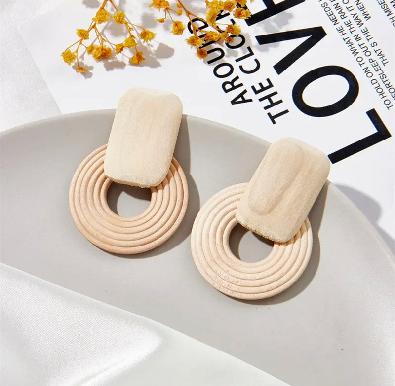 Clip on 2 1/4" gold and wood earrings in dark brown, white, or light brown