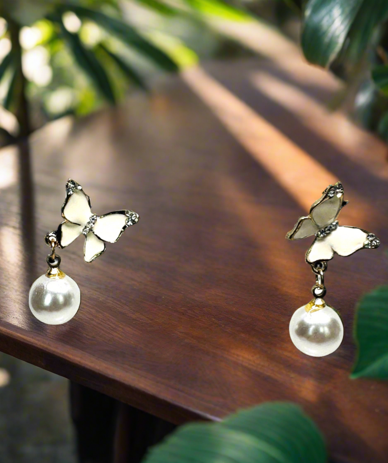 Pierced 1 1/2" gold and white butterfly and pearl dangle earrings