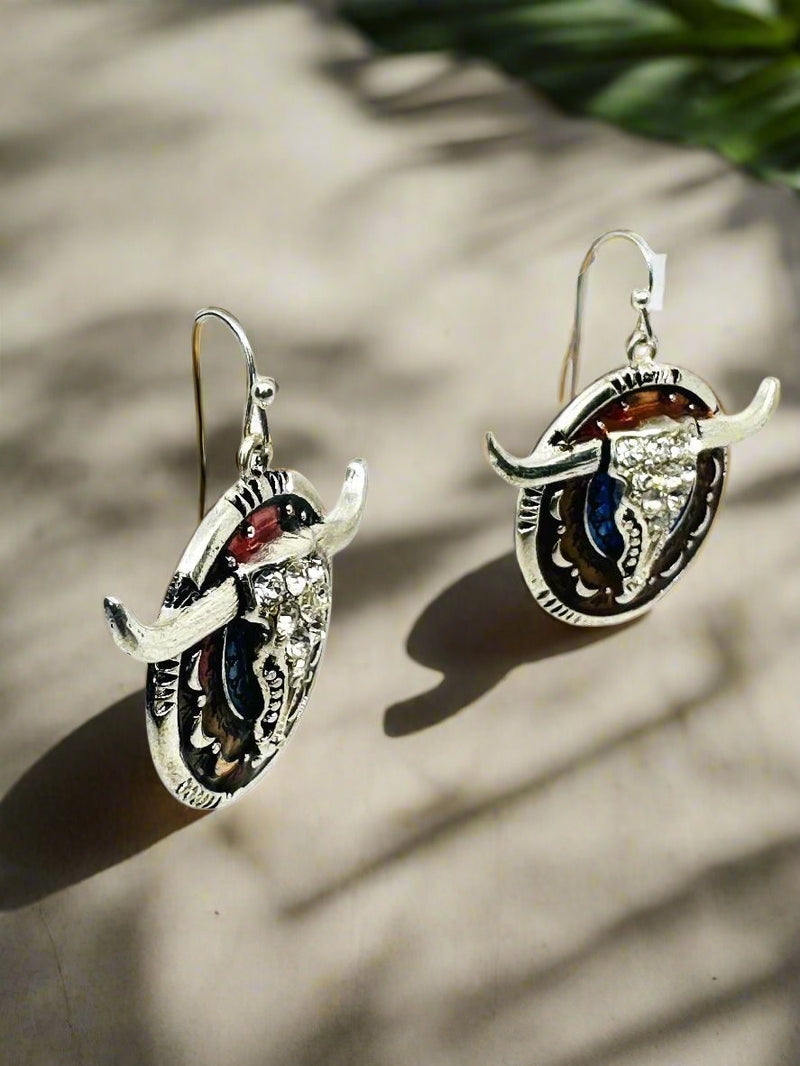 Pierced 2 3/4" silver, brown, and blue bull earrings with clear stones