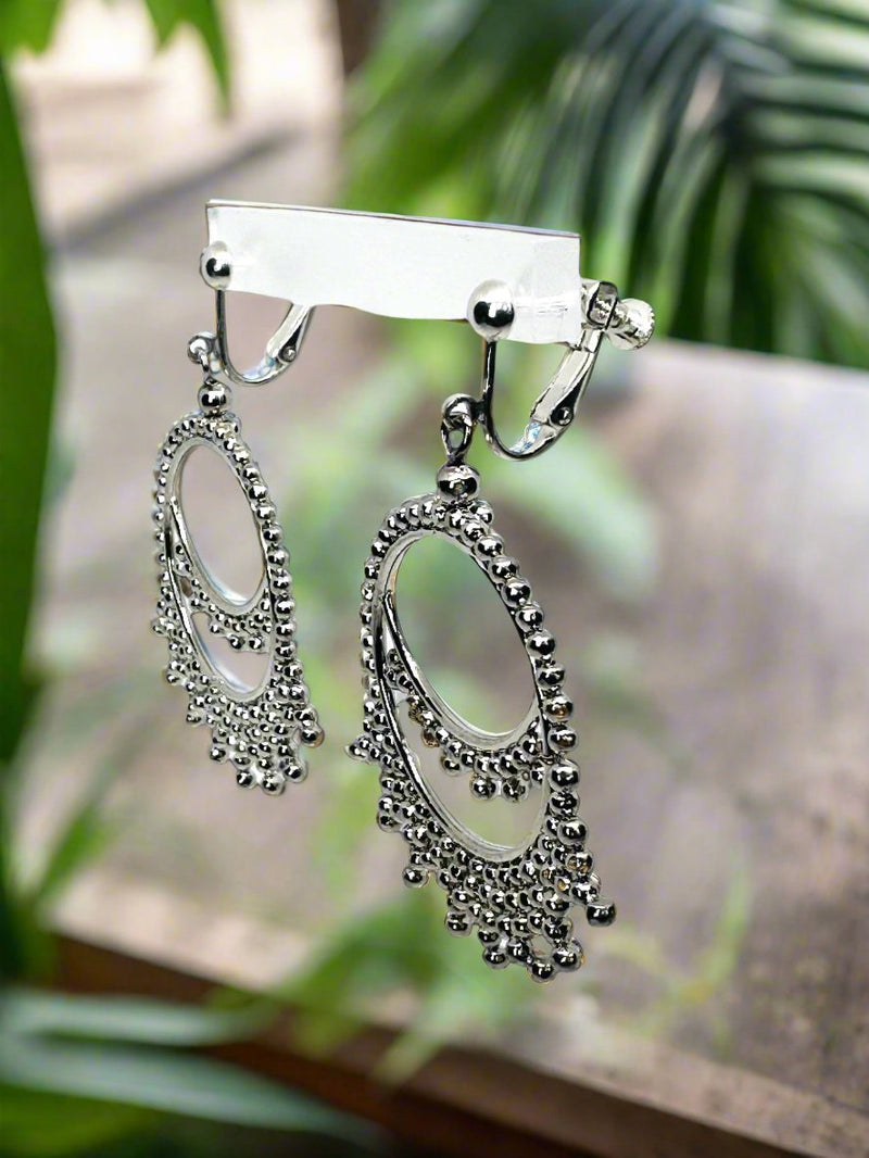 Clip on 2 1/2" silver cutout crown style dangle earrings