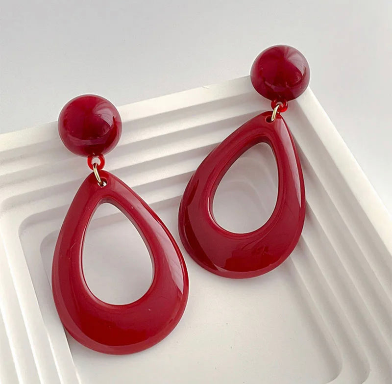 Clip on 2 3/4" gold and dark red hard plastic dangle teardrop earrings