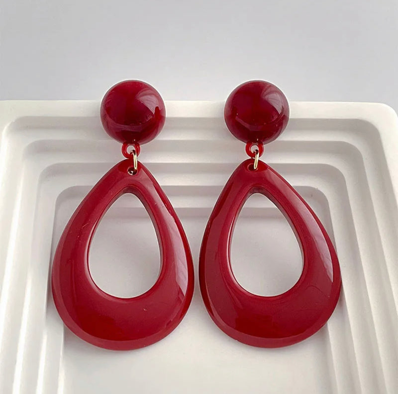 Clip on 2 3/4" gold and dark red hard plastic dangle teardrop earrings