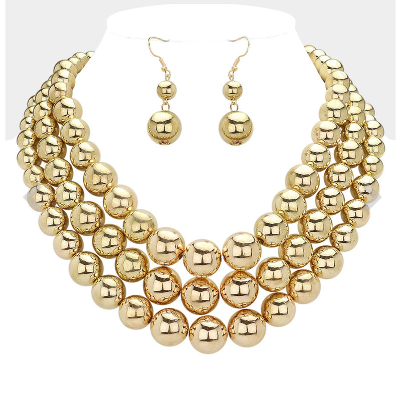 Pierced shiny gold three layered necklace and earring set