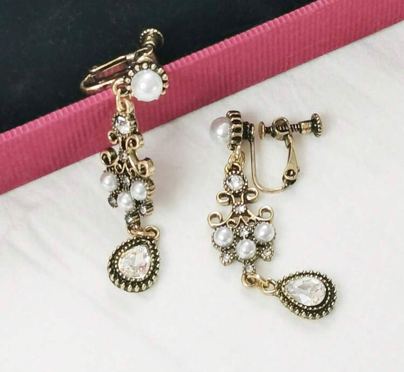 Vintage 2 1/4" clip on brass, clear stone, and pearl dangle earrings
