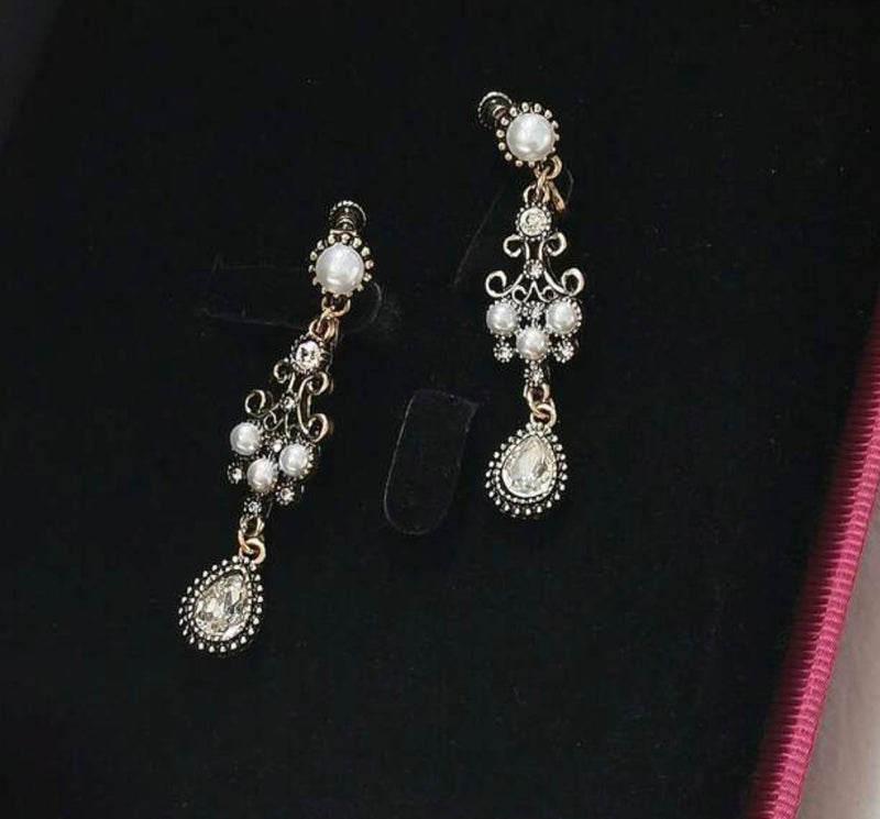 Vintage 2 1/4" clip on brass, clear stone, and pearl dangle earrings