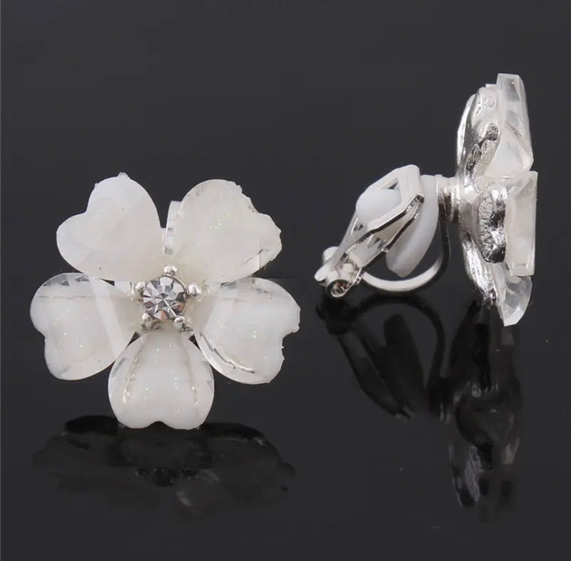 Clip on 3/4" silver and glitter white heart flower earrings with clear stone