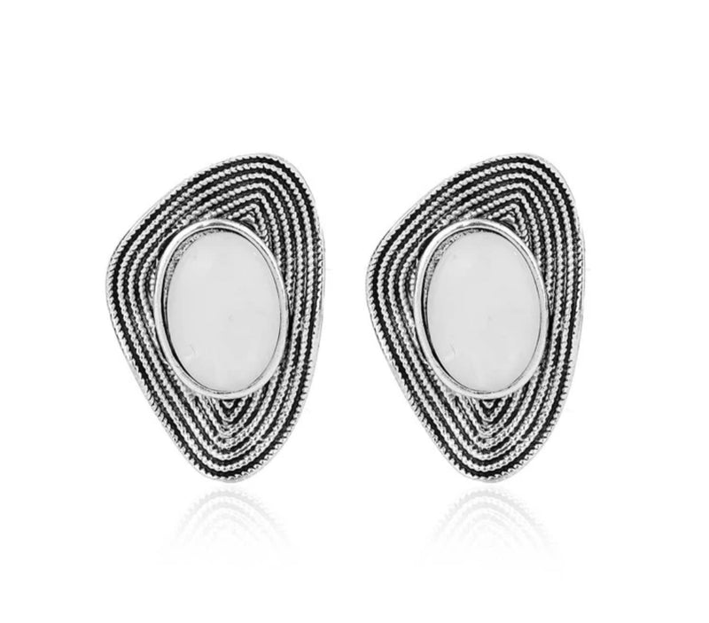 Clip on 1 1/4" silver and black wavy indented earrings with white center stone