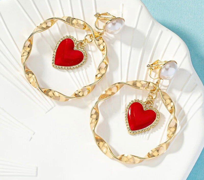 Clip on 2 1/2" gold and pearl twisted hoop earrings with center dangle red heart