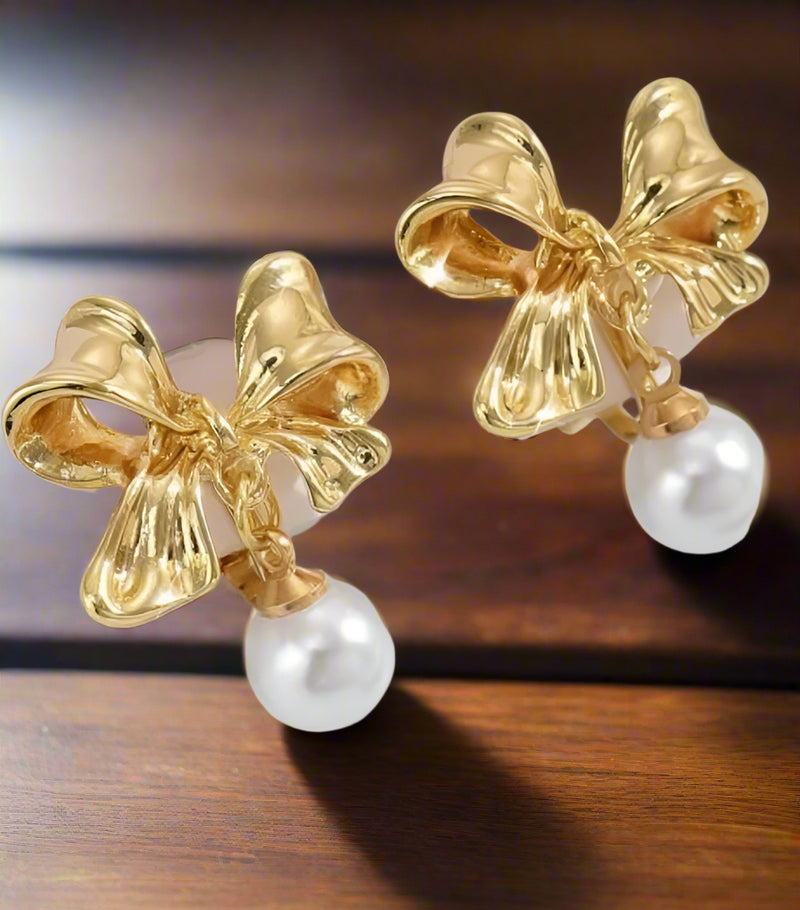 Clip on 1.25" gold bow earrings with white dangle pearl