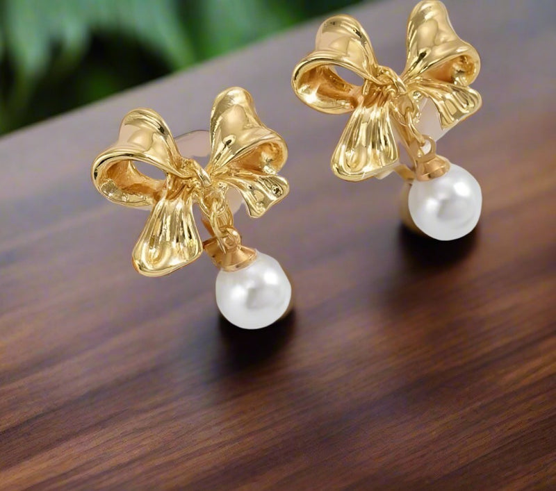 Clip on 1.25" gold bow earrings with white dangle pearl