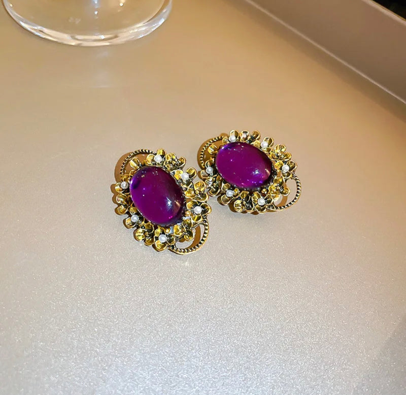 Clip on gold purple stone earrings w/cutout edges & small pearls