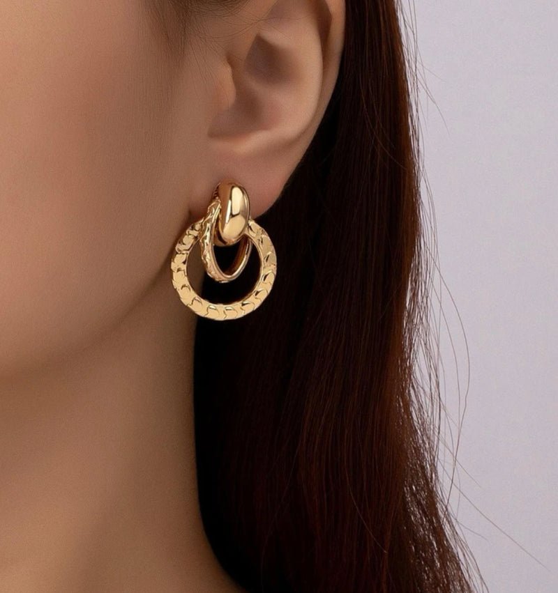 Pierced 1 1/4" gold textured loose knot button style earrings