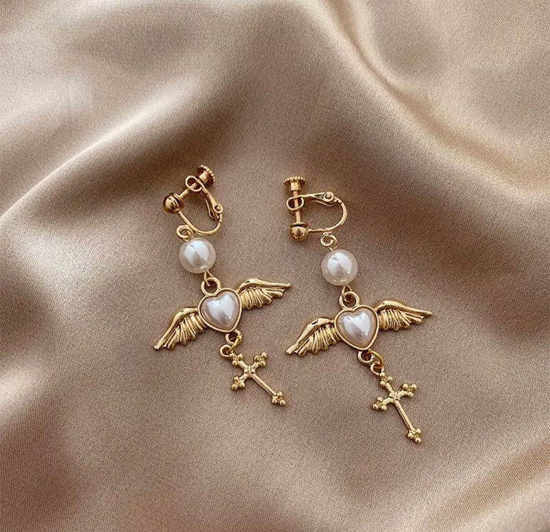 Clip on 2 1/4" gold white pearl heart, wing and cross dangle earrings