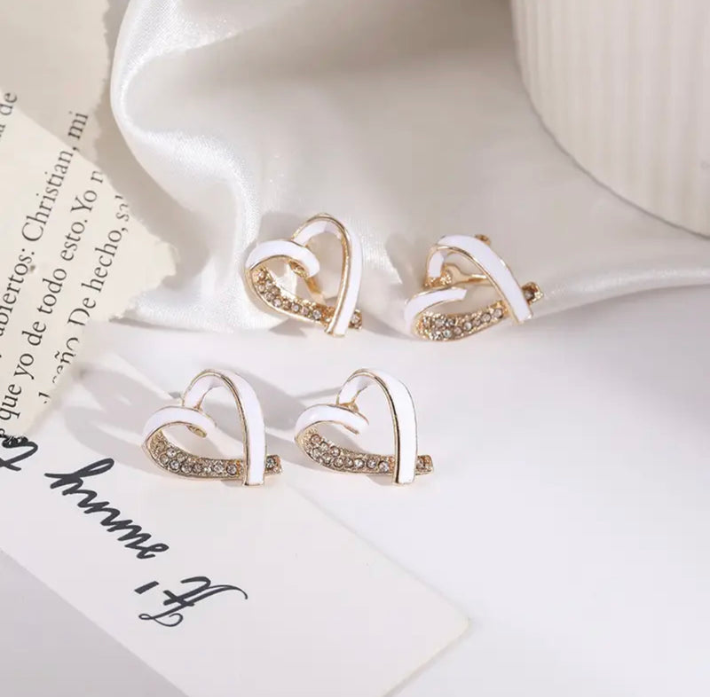 Clip on 1 3/4" gold and white heart earrings with clear stones