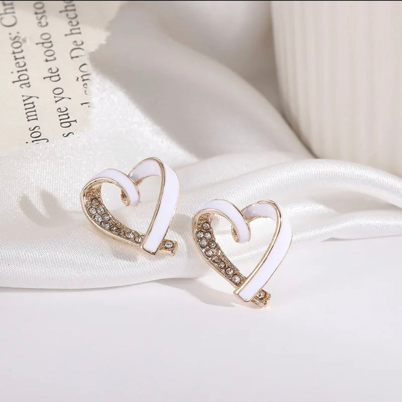 Clip on 1 3/4" gold and white heart earrings with clear stones