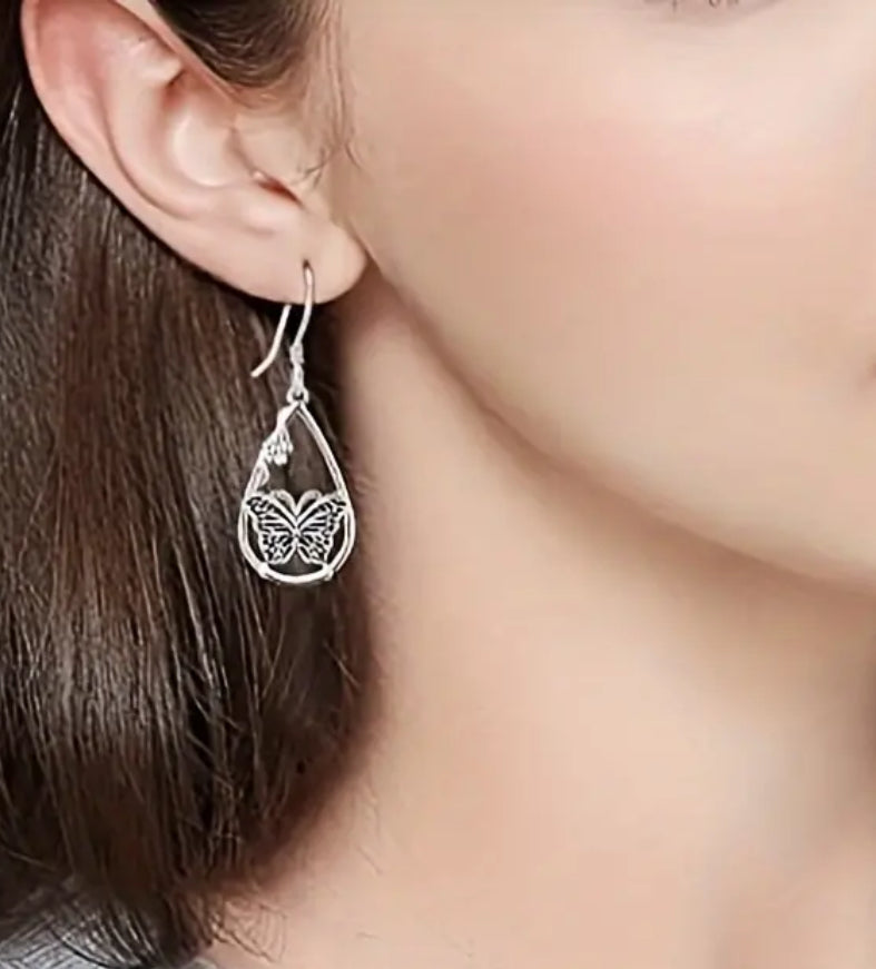 Pierced 1 3/4" silver teardrop earrings with center butterfly