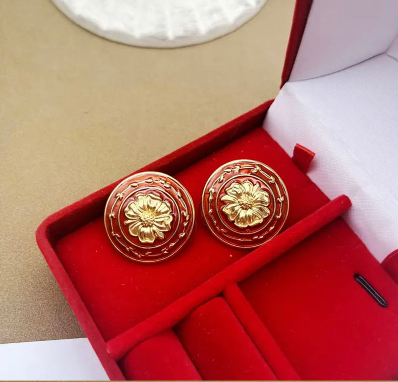 Clip on 1" matte gold and red flower button style earrings