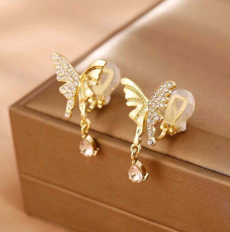 Clip on 1 1/4" gold indented and clear stone butterfly earrings