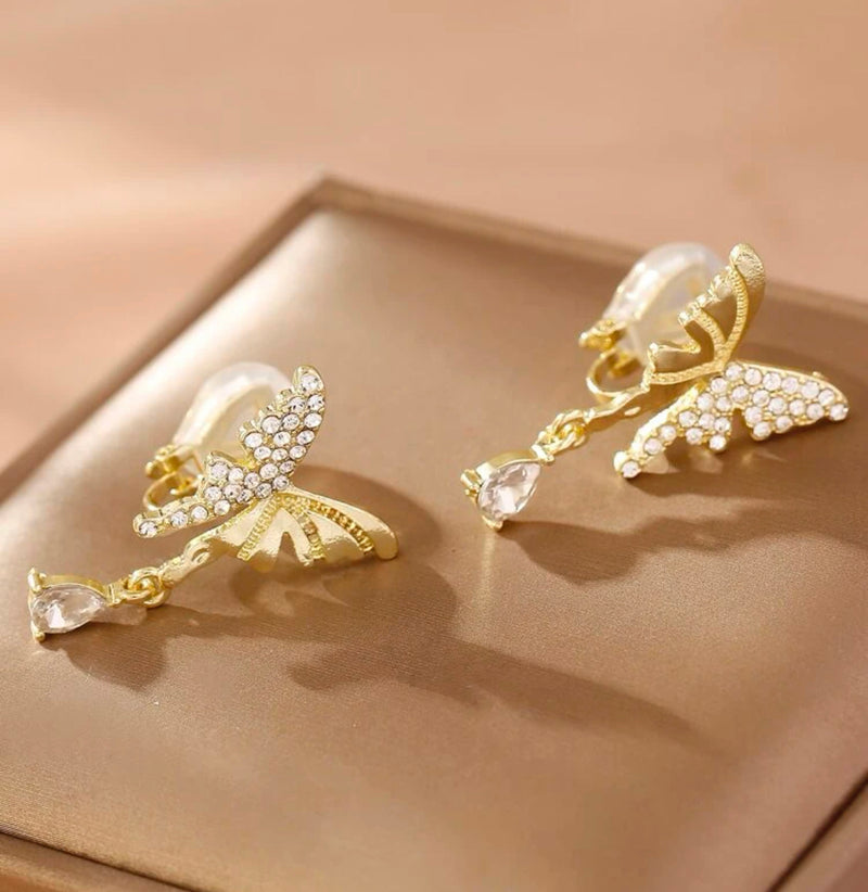 Clip on 1 1/4" gold indented and clear stone butterfly earrings