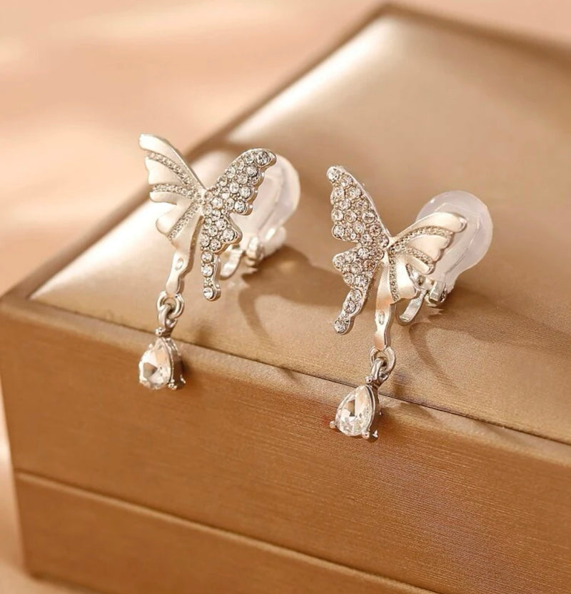 Clip on 1 1/4" silver indented and clear stone butterfly earrings