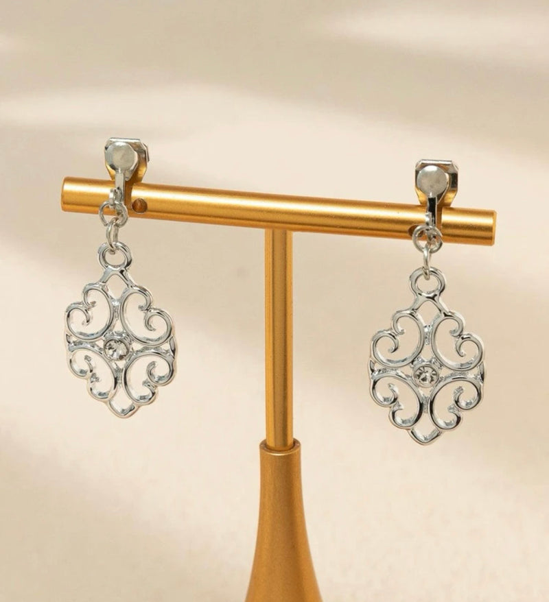 Clip on 2 1/2" matte silver wavy pointed cutout dangle earrings