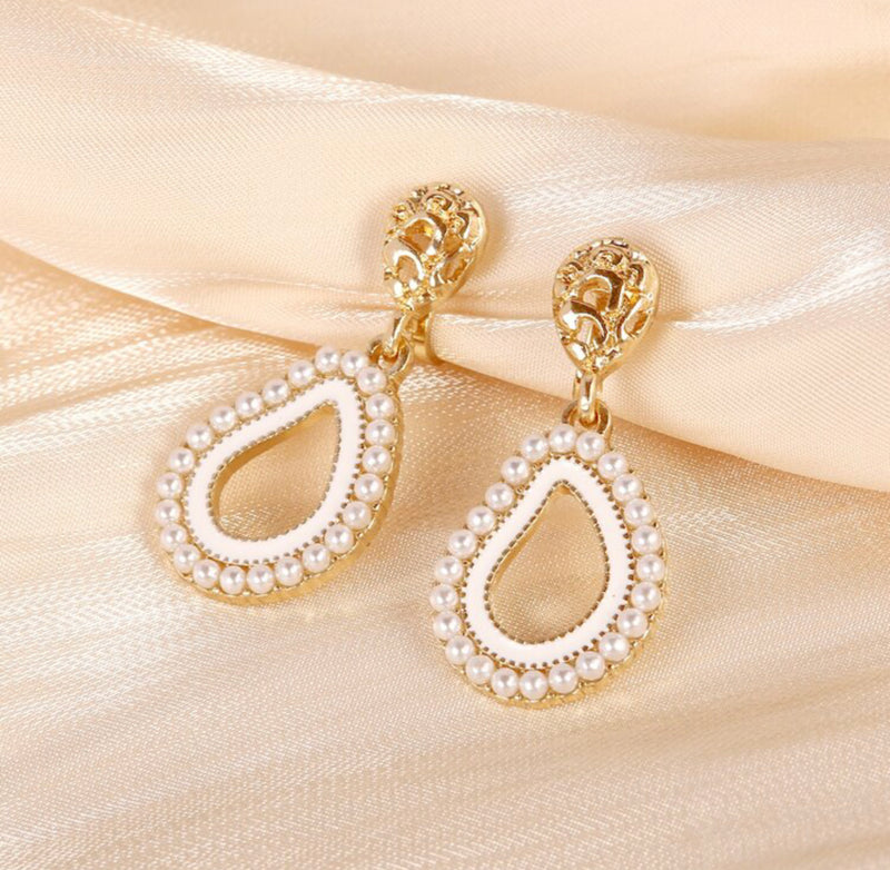 Clip on 1 1/2" gold, white pearl earrings with clear stone edges