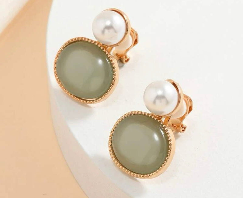 Clip on 1 1/2" gold, white pearl earrings with clear stone edges