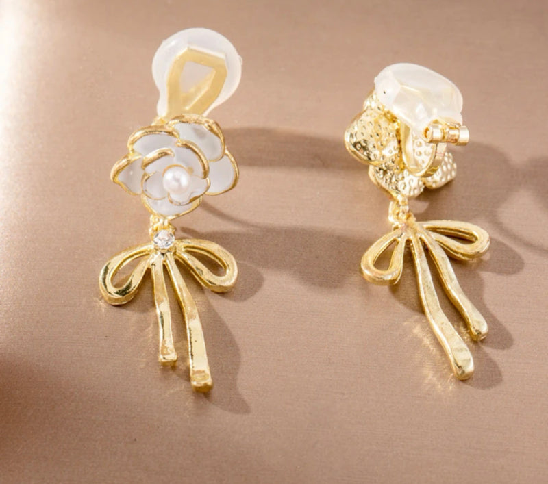 Clip on 1 1/2" gold and white flower earrings with dangle bow and pearl