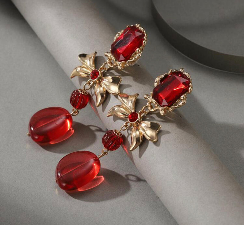 Clip on 3 1/2" gold and red stone dangle bow earrings with red dangle bead