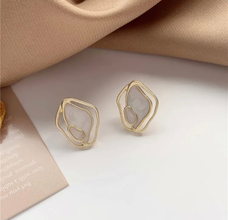 Clip on 1" gold and center white odd shaped button style earrings