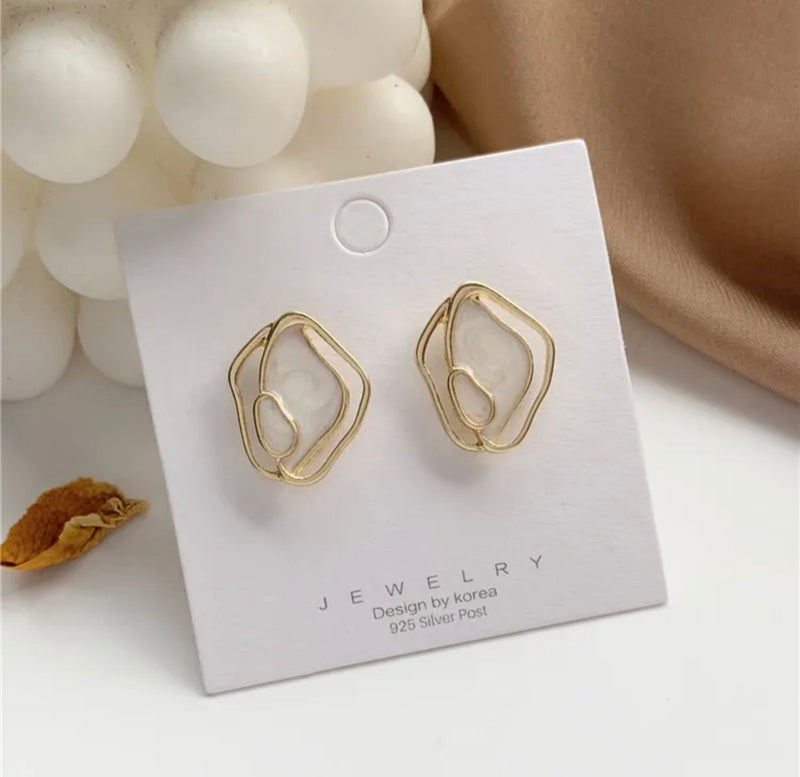 Clip on 1" gold and center white odd shaped button style earrings