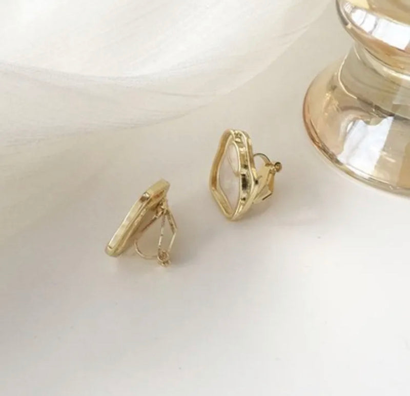 Clip on 1" gold and center white odd shaped button style earrings