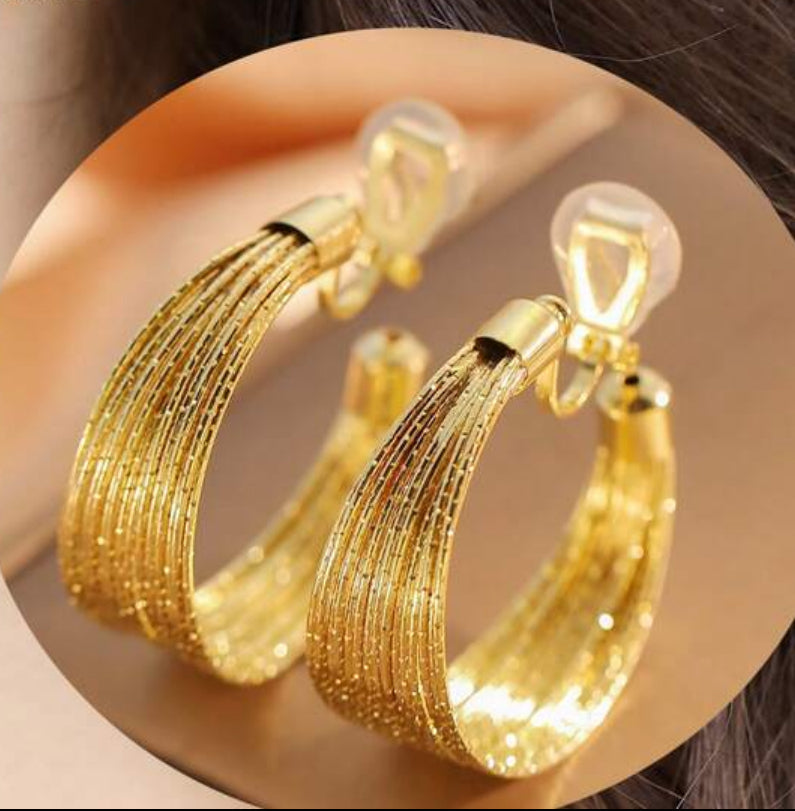 Clip on 1 1/2" sparkle gold wire graduated open back hoop earrings