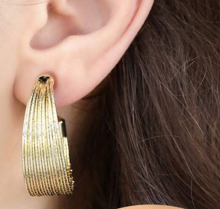 Clip on 1 1/2" sparkle gold wire graduated open back hoop earrings