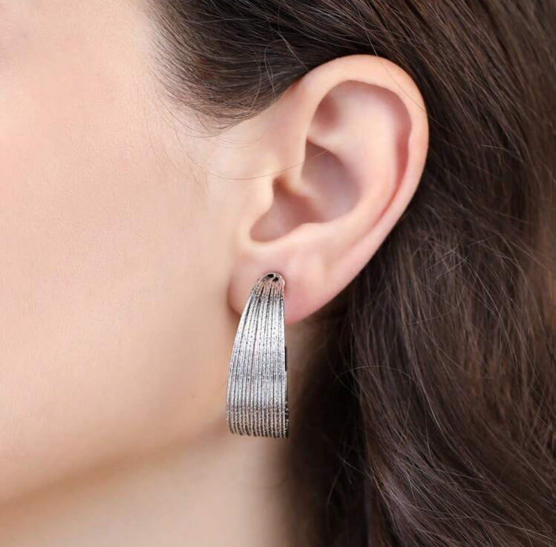 Clip on 3/4" gold and fluorescent white cutout flower earrings