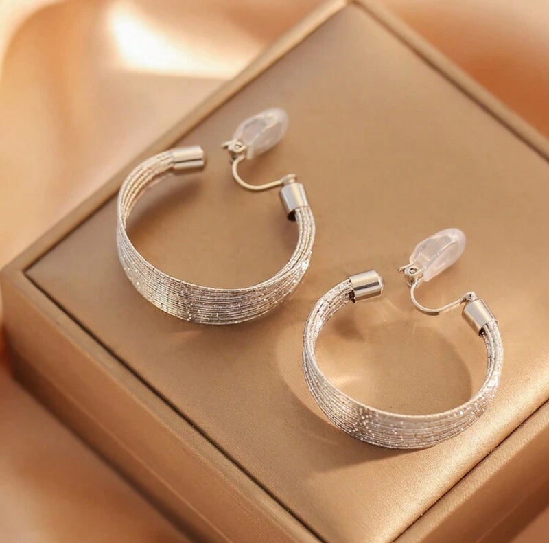 Clip on 1 1/2" sparkle silver wire graduated open back hoop earrings