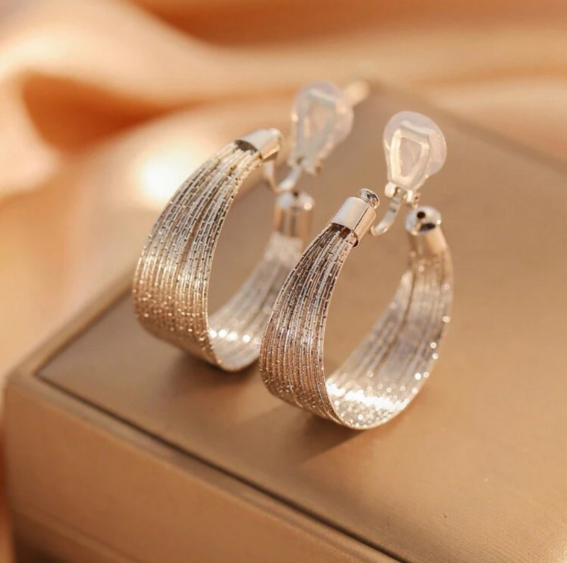 Clip on 1 1/2" sparkle silver wire graduated open back hoop earrings