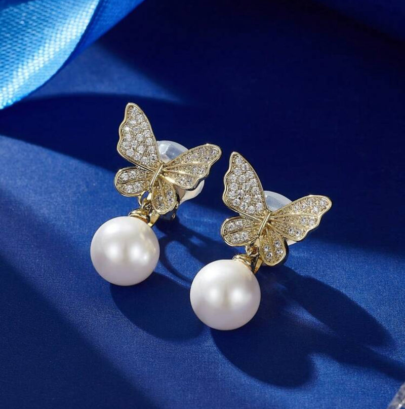 Clip on 1" gold and clear stone butterfly earrings with dangle pearl